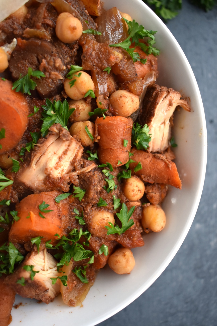 Slow Cooker Moroccan Chicken is loaded with flavor, tender chicken, carrots, chickpeas, pears, Moroccan spices and more for the perfect cozy meal! Serve over brown rice, cauliflower rice or quinoa. www.nutritionistreviews.com #healthy #cleaneating #dinner #slowcooker #chicken #crockpot