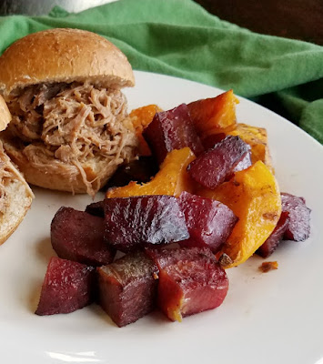 Roasted fall vegetables are made perfectly tender and lightly caramalized with a hint of Chinese five spice to give them that extra something. It's a delicious fall side dish. roasted veggies on plate with pulled pork sliders