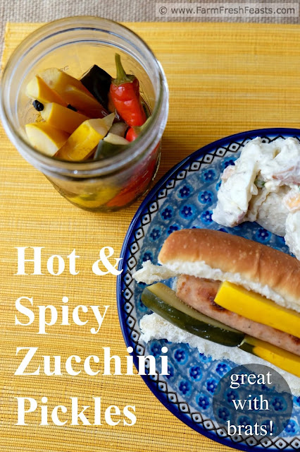 a photo of a bratwurst sandwich along with a jar of hot and spicy zucchini pickles and potato salad