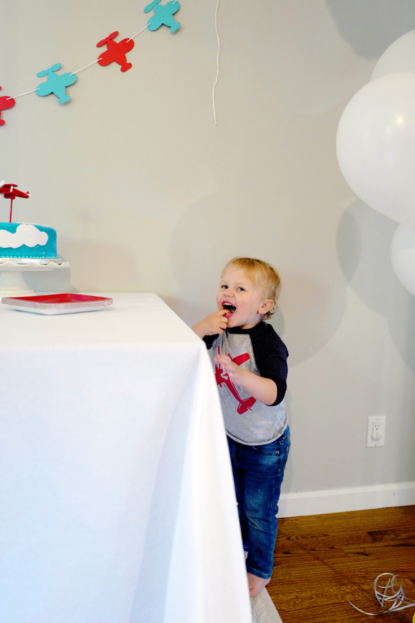 The birthday boy sneaking frosting