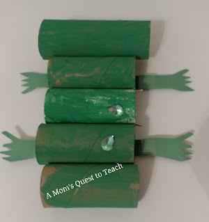 attaching legs to green paper towel tubes for alligator craft