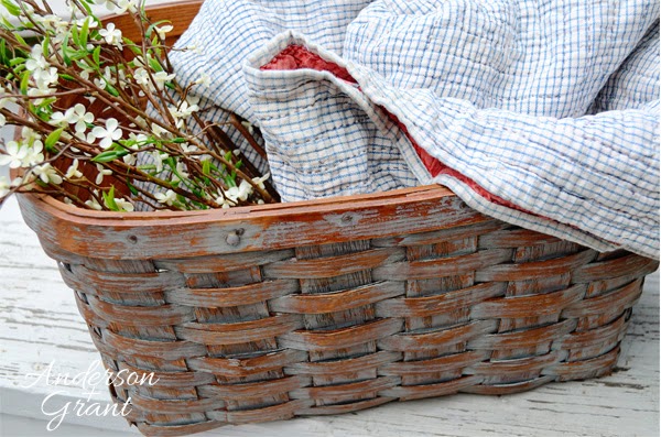 This great decorative basket was made by removing the lid and handles from an old picnic basket.....Now it is a great storage place for a quilt, some magazines, or flowers!  | www.andersonandgrant.com