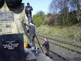 David, Richard and James changing the water column hose at Andrews House