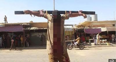 1a4 ISIS terrorists crucify spies, cut off man’s finger for stealing and throw another off the roof for being gay. (Graphic Photos)