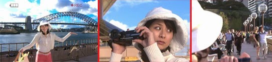 Sekiyama poses in front of the bridge, but when she's filming, she catches sight of Tsutsumi talking with a woman.