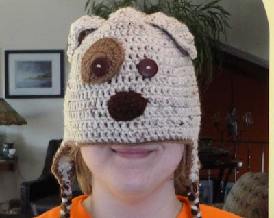 woman wearing crocheted dug hat over face