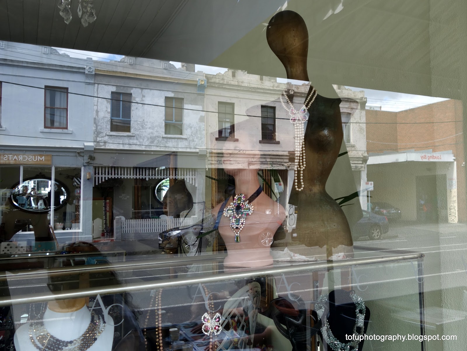 Tofu Photography Buildings reflected in a jewellery shop in North