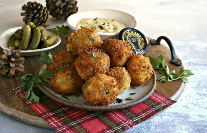 Crispy mustard coated fried potato balls with cheese.