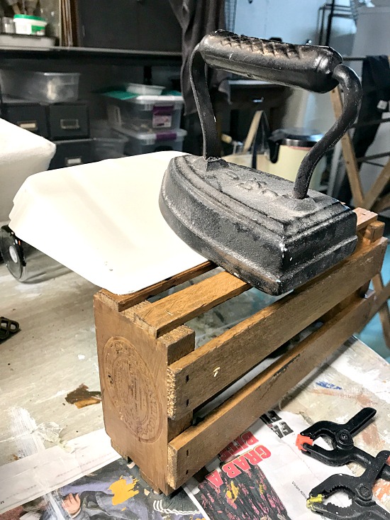 Gluing the dustpan to the crate weighted with an iron