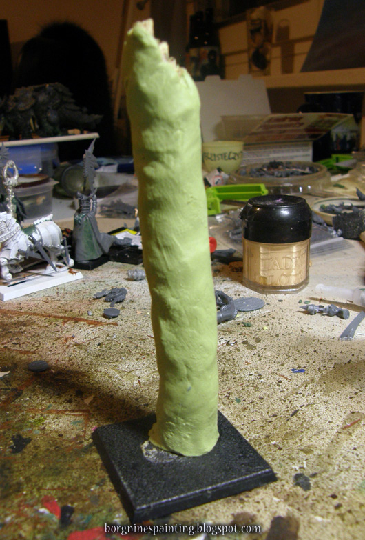 The stick is standing vertically and the greenstuff-milliput mix is wrapped around it.