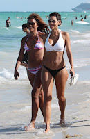 Nicole Murphy takes a walk on the sandy beach with a friend