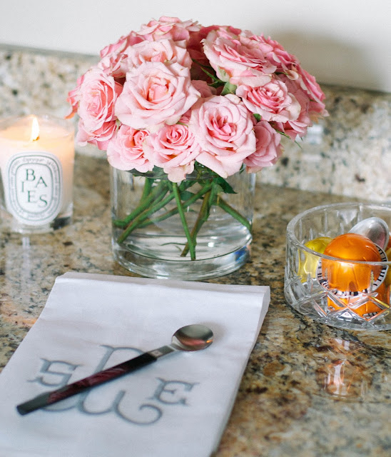 diptyque baies candle and garden roses and monogrammed hand towel