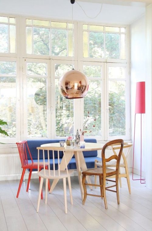 eclectic and colorful various chairs dining area