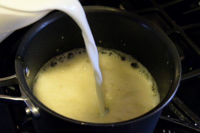 Milk being added to the butter and flour mixture. 