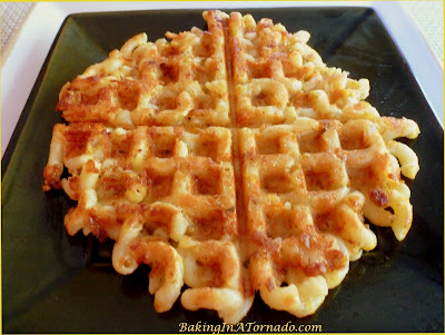 Mac and Cheese Waffles and Honey Bunches Chicken: cruchy cheesy Macaroni and Cheese waffles with a hint of bacon, topped with Honey Bunches  crusted Chicken and drizzled with Maple Syrup | Recipe developed by BakingInATornado.com | #recipe #waffles #chicken