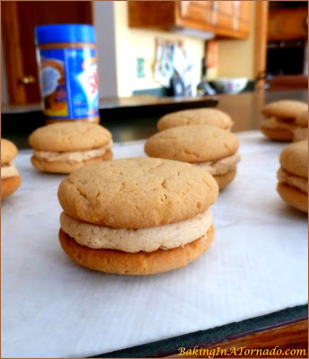 Peanut Butter Lover’s Sandwich Cookies, peanut butter flavored cookies sandwiched with fluffy peanut butter filling. | Recipe developed by www.BakingInATornado.com | #recipe #cookies #peanutbutter