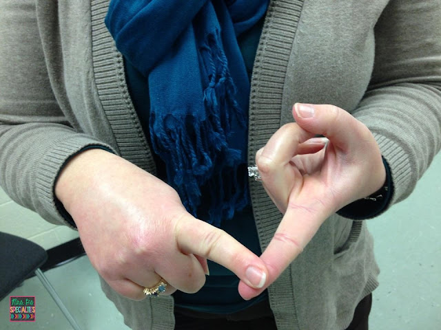 photo of teacher touching 1 finger