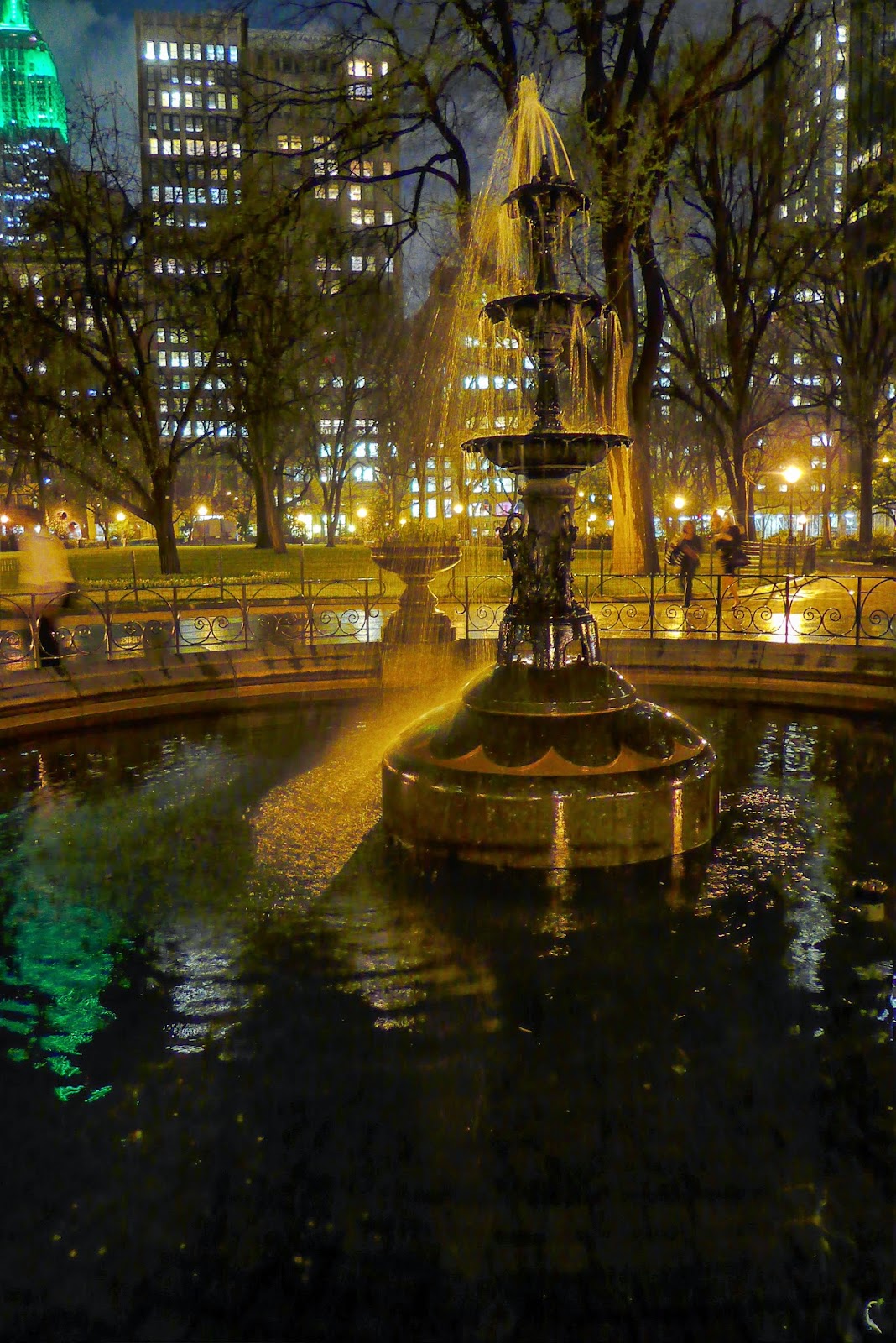Madison Square Park fountain, night, rain