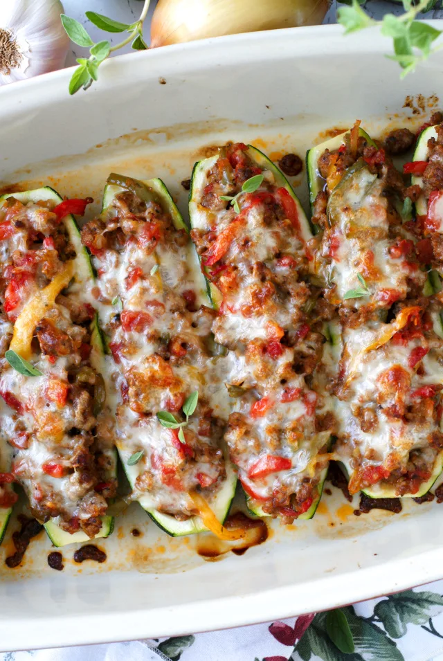 Sausage, Pepper, and Onion Stuffed Zucchini Boats are a twist on the classic northern dish, made by swapping the roll with bright and fresh zucchini boats! | thetwobiteclub.com | #JDFamilyTable #ad