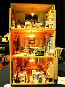 Back view of a modern miniature shabby chic shop, showing three levels of sales areas.