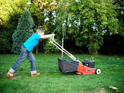 boy mowing lawn