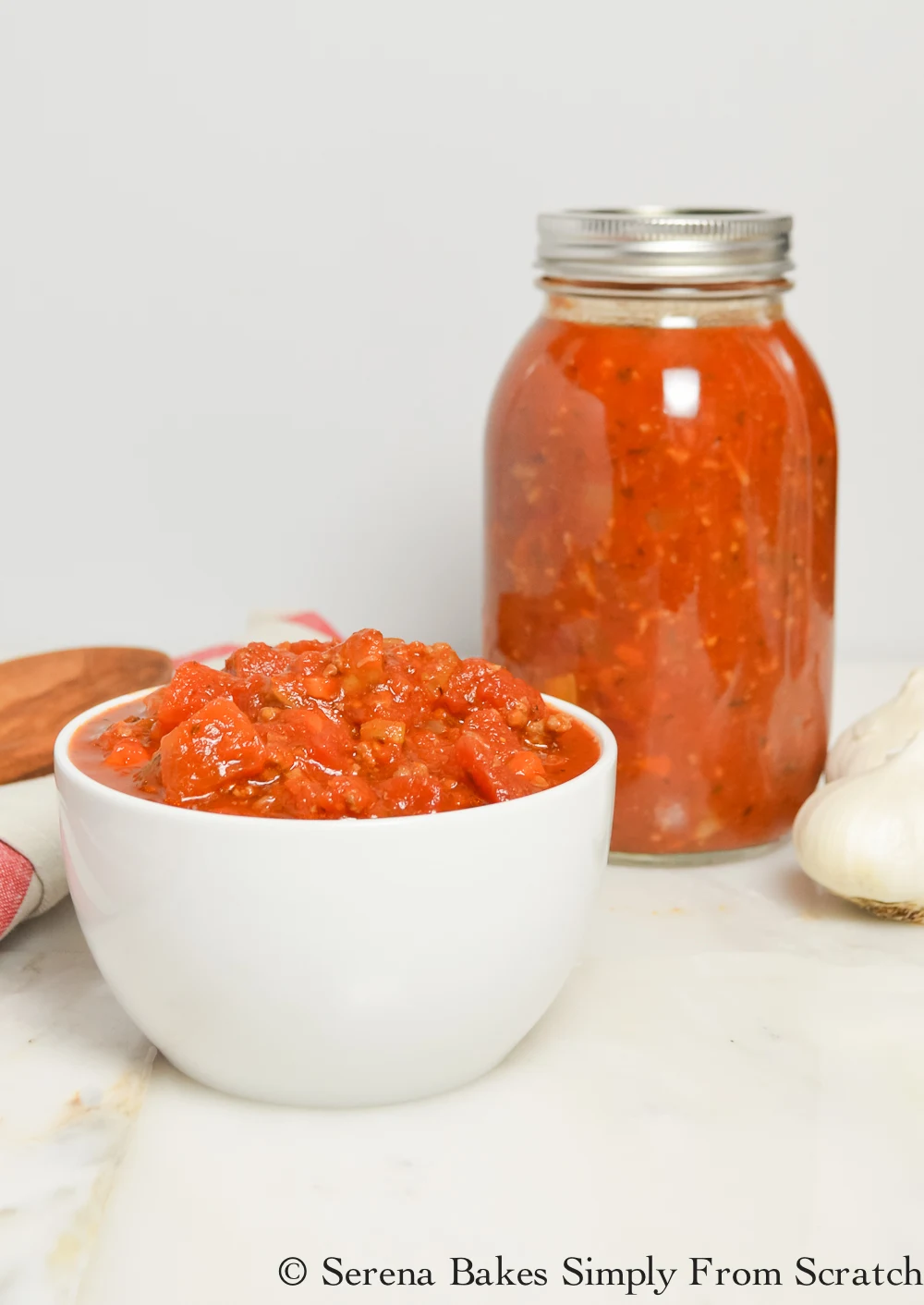 Homemade Spaghetti Sauce is easy to make and a great way to stock the freezer! Full of lots of meat and veggies. serenabakessimplyfromscratch.com