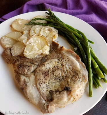 Make your pork chops and scalloped potatoes in the same pan for even bigger flavor and fewer dishes! Maw-Maw definitely had the right idea when she started making this delicious dinner! dinner plate with pork chop, potatoes and asparagus
