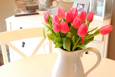 pink tulips in white pitcher