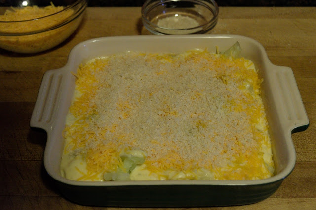 Panko bread crumbs and Parmesan being added to the the dish. 