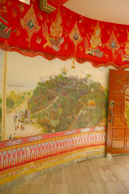Buddhist temple Wat Kao Poon is explained  in an illustrated hand painted story on the walls. 