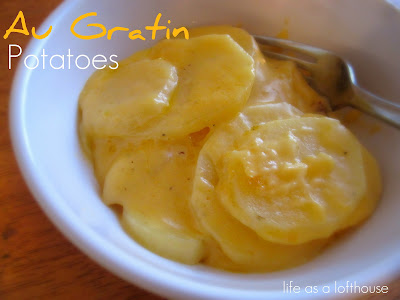 Au Gratin Potatoes are creamy and buttery potatoes covered in a gooey cheese sauce. Life-in-the-Lofthouse.com