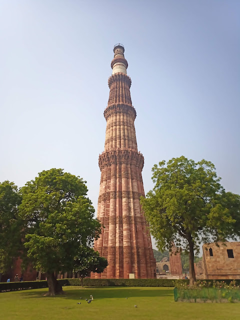Monumentally tall Qutub Minar minaret at Qutub complex in Delhi