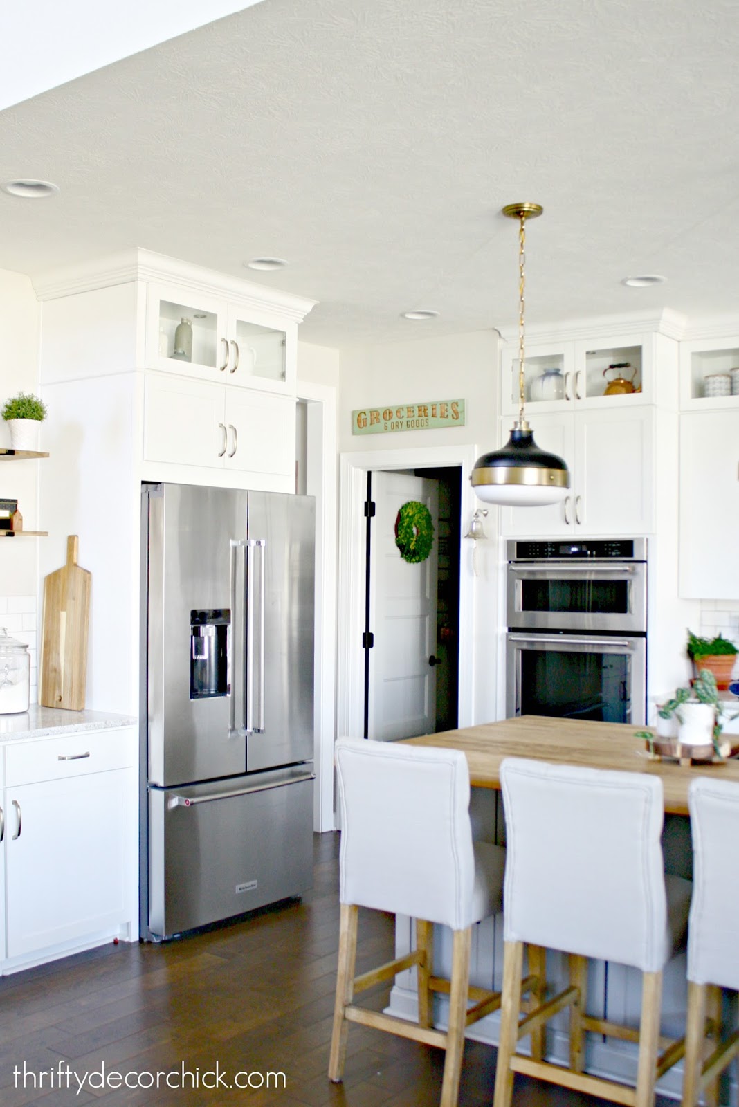 White kitchen with wood and gray island 