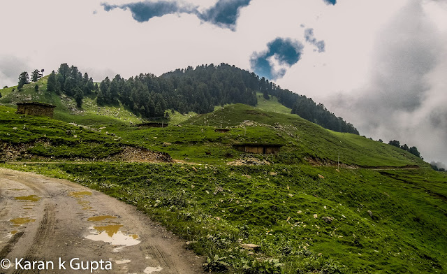 Hello everyone. I may not be good with words but somehow I am going to share about one of the most exciting and memorable trip I had with my family during monsoons of 2012The destination was Prashar lake, situated at a height of 2730 meters above sea level, 49 km north of Mandi, a buzzling town situated in Himachal Pradesh. It’s a place about which very few people know, but once anyone visits Prashar, he longs to come back againFor convenience of visiting tourists, recently HPPWD and HP Forest Department constructed different rest houses. In addition a Trekker’s Lodge was also constructed which is more sophisticated than othersThe bookings can be done from respective offices in MandiAfter making all the necessary arrangements including food etc. , we a group of 15 family members started from Mandi at about 4 pm. It was a risk though in monsoons because almost 25 km of road was a muddy tarmac and had become slippery, thanks to some contractor who didn’t do a good jobAs we came closer to our destination, more the chill in air increased. This was my second visit to Prashar. Earlier I had trekked almost 14 kms to reach there way back in year 2000. The route chosen was via Katindi, Kataula and last thickly populated place en route is Baghi, which is 28 kms from Mandi approximately. Till here the road condition is good. After crossing Baghi you will find lesser number of inhabitants. As you move higher, just 5 km before Prashar you will find one room mud & stone houses, inhabited by shepherds or gaddi’s as they are locally knownWe reached Prashar at 7 pm as last 14 kms of distance had to be covered in fog. The temperature was a whooping 2 degrees celcius in evening. After some tea everyone settled down in quilts and blankets, as that was no doubt the need of hour. With fog and darkness all around there was nothing to be explored nearby, so after a tasteful dinner I sleptI woke at around 6 am in morning. The scenery outside was mesmerizing. It had rained during night. The clouds were making way for mountains to be seen. The cold didn’t stop me from getting my camera and go for a short exploration spree around. The surroundings were full of many types of flowers. The area had various types of flora.At around 8 am it started raining again, and that is when I noticed one of our cars had a flat tyre. It was replaced then and there as chances of heavy rainfall were expected in later part of the day. At such places there are no workshops etc. so one has to come well prepared beforehandOnce all were ready luckily it stopped raining. We all started for the famous Prashar Rishi Temple and Lake. It’s a 15 minute walk from the rest house when you reach and gaze down to see a lake having crystal clear water and a temple premises consisting of three pagoda architecture buildingsThe myth about Prashar Lake is that it was formed after Saint Rishi performed meditation hereThe depth of the lake is still uncertain. Rumors are that the main temple is beneath the lake.  It is also said that there is a big treasure beneath the lake, but no one dares to go and find out. Once some foreign national took a dip in lake to reach the depth.  It is said that once he returned he lost his visionBeing a Sunday the secluded place was abuzz with activity with many tourists thronging to seek blessing and enjoy their SundayOne can make out that how much worshipped diety is Prashar Rishi as large number of followers were seen seeking blessingsThere are two shops which serve delicious rajmah-rice and tea in vicinity of lakeAs the day was foggy, the beauty of Lake was at its bestOne must surely visit the place.