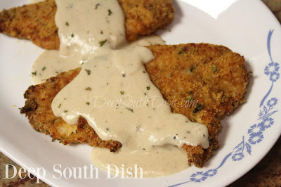 Boneless, skinless chicken breasts, pounded thin, dipped in an egg and hot sauce blend, dredged in a seasoned buttery Ritz cracker mix and pan-fried or baked, and topped with a buttery pan gravy before serving.