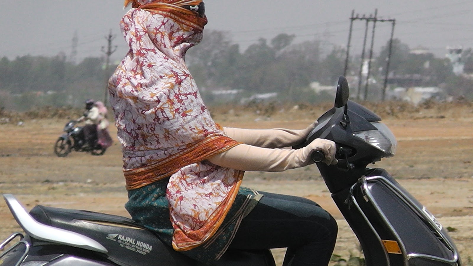 Daemon's Indian women in gloves, Indian women riding scooty