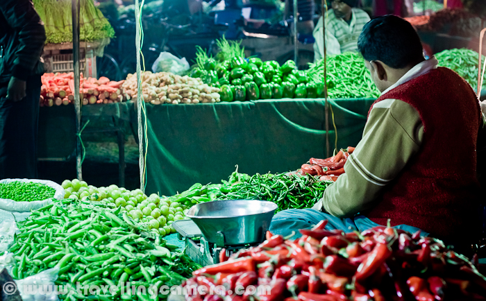 During Christmas vacations, I was in Chandigarh and was staying with Naresh at Mohali. So on thursday, we visited one of the vegetable market at Phase-3B2, mohali and found this little interesting... Let's check out this Photo Journey from this weekly Vegetable Market...Clicking photographs in such markets is not a usual thing and at times, vegetable vendors don't like (which can be interpreted from their expressions.) So we have clicked photographs of shops/kiosks, where we bought something.In most of the big cities/towns of India, there is a trend of weekly vegetable markets. At some places, farmers from surrounding areas come with fresh vegetables to a common ground. While in cities  around Capital region, vegetables vendors come up with various vegetable options picked from main store.In cities like Mohali, Chandigarh are closer to agricultural regions, so have an advantage of accessing fresh vegetables and fruits. In fact, lot of local stuff is also available quite easily...It was wonderful experience to roam around a place with all fresh vegetables, fruits and other local stuff. People from villages calling the customers with extreme humbleness and many times, no need of negotiations. They sell vegetables, fruits, sugarcane etc at very reasonable rates. Most of the vendors deal only in selected items. For example, vegetable vendor in this photograph is only selling potatoes and peas.Colorful vegetables lying across the rows in this market @ Mohali, Punjab, India.Freshness of these vegetables or fruits, at times, compel to overbuy due to cheaper rates. So it's always important to know the need, before heading towards these markets. It's always tempting to stop by every kiosk and ask for rates and fill the bags :) ... I know it's not possible to estimate the amount and type of vegetables/fruits required for next few days, but it becomes important when you are shopping at these moving markets and not supermarkets around your house.Please have a look at http://spiceflair.com/the-farmers-market-of-india-sabzi-mandi/This link shares an interesting experience of Sabzimandi and memories from childhood of author, who has recommended some of the tips for shopping in moving Sabzimandi around your place'Gurh' - Almost all moving vegetable markets will have this stuff, which is made up of sugarcane and mostly processed locally by farmers. I recommend to never visit the place where it's processed, because that may lead you to not use this stuff :) ... In fact, same is the case with Sugar Factories. In that case, even you need not to go inside the factory.In most of the planned cities, appropriate authorities facilitate these markets. Things like benches on rent are provided to farmers, so that they need not to worry about the such heavy things. Apart from this, authorities need to take care of providing appropriate space for farmers and cleaning of the same space next day. So farmers come up with stuff they want to sell, some small equipments for lighting the space and covers-wraps in case of rains etc.Bananas... Almost every seasonal vegetable and fruits can be found in these markets. Apples, Bananas, Grapes, Pomegranates in fruits and vegetables like -  Beetroot, Bitter Gourd, Bottle Gourd, Brinjal, Cabbage, capsicum, Carrot, Cauliflower, Coriander leaves, Corn, Cucumber, Curry leaves, French Beans, Fenugreek leaves, Garlic, Ginger, gooseberry, Green Mustard, Green Peas, Green Onion, Lady Finger,Lemon, Maize, Mint, Mushroom, Onion etc...Here is a nice link with some of the names of vegetables in English and translation in Hindi or what we call them in India - http://www.syvum.com/recipes/indian/glossv1.htmlOne of the vegetable only selling things like Red and Green chillies, gooseberry & green chickpea etc.Sparkling lights around colorful vegetables @ Moving Sabzimandi, Mohali, Punjab, India !!For health conscious people, there is lot of information available on web. Like healthiest vegetable for winters etc.. One of the similar link can be seen at http://eatdrinkbetter.com/2008/12/12/seasonal-eats-5-best-winter-vegetableSabzimandi is also a good place to look for daily-use stuff in some of the shops around the main market. These shops are extremely useful at times...Not only daily use stuff, but cloths, bed-sheet and other stuff is also sold. I am not sure how popular such shops are but I always these them around moving Sabzimandi... I was standing at this point for 10 minutes, didn't see even a single customer for him. Hope he makes good money during the time he spent in chilling winters.As a bachelor, I hardly go to these markets. In Chandigarh, I got this opportunity to visit this Sabzimandi with my friend. Hope to visit the Monday Vegetable Market in Noida as well. It's very close to my office :) ... Hope to share another Photo Journey on Noida Sabzimandi soon... 