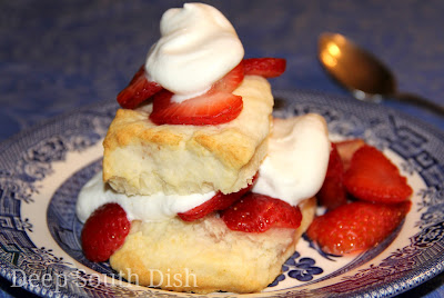 Sugar macerated strawberries served over homemade cream biscuits with homemade whipped cream.