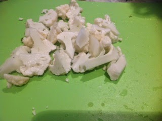 cut up cauliflower on a cutting board