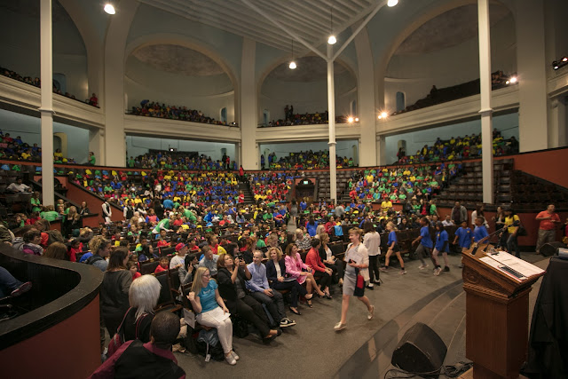 Large auditorium with students listening to a speaker
