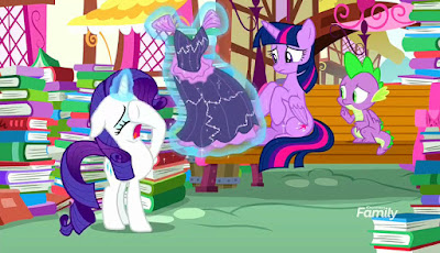 A crying Rarity, levitating a poor-quality dress, talks to Twilight. They're surrounded by books
