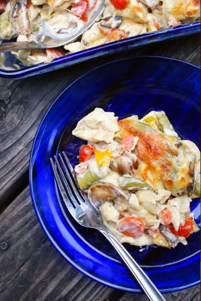 This decadent Tortellini and Garden Vegetable Bake is brimming with tons of sweet vegetables like sugar snap peas, carrots and cherry tomatoes baked with cheese tortellini in a creamy mushroom sauce