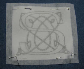 Stabilizer fabric pinned over monogram