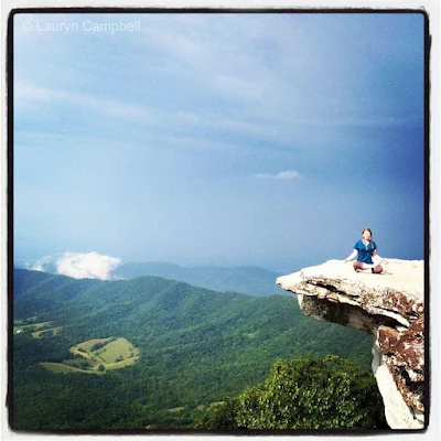 Lauryn "Slaughterhouse" Campbell meditating on a rocky cliff while on The Appalachian Trail 