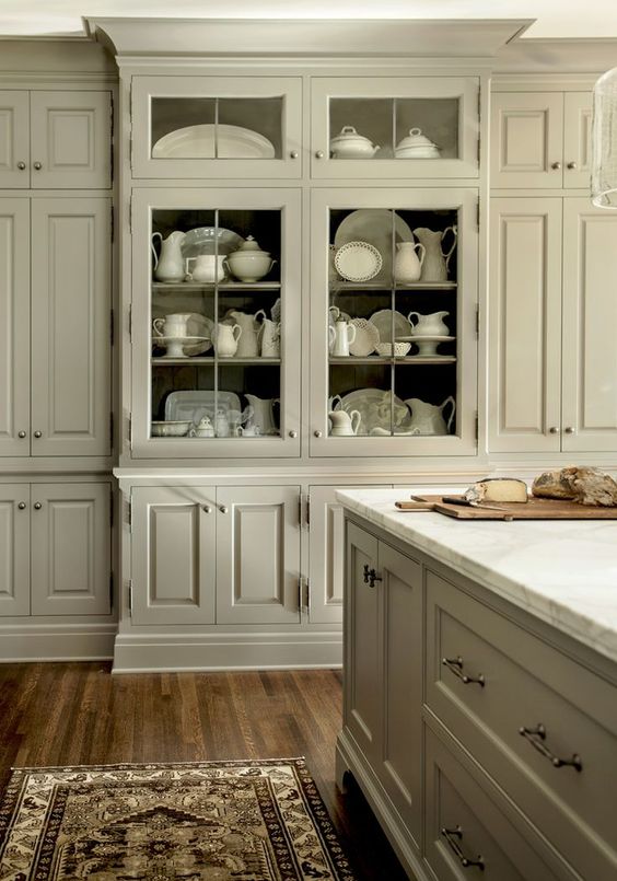 White Kitchen w/ White Antique Pottery Collection Content in a Cottage