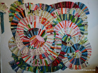Improvisational curve quilt in shades of pink, coral, red, blue, green and white