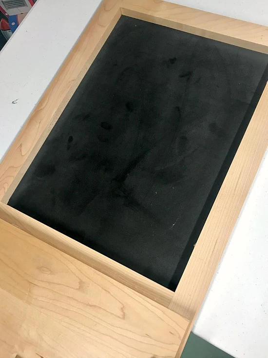 Adding pre-made chalkboard to a repurposed cabinet