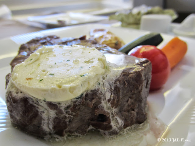 JAL First Class trip report on JL005 - Main Dish - Grilled Fillet of US Prime Beef with Roasted Garlic Sauce & Anchovy Butter