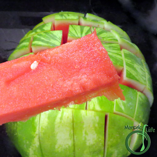 Morsels of Life - How to Cut a Watermelon Step 4 - Turn watermelon a quarter turn, and cut again. If you're smarter than me, you'll have your watermelon on a serving dish. Once you've made the cuts, just grab a piece and eat! :)