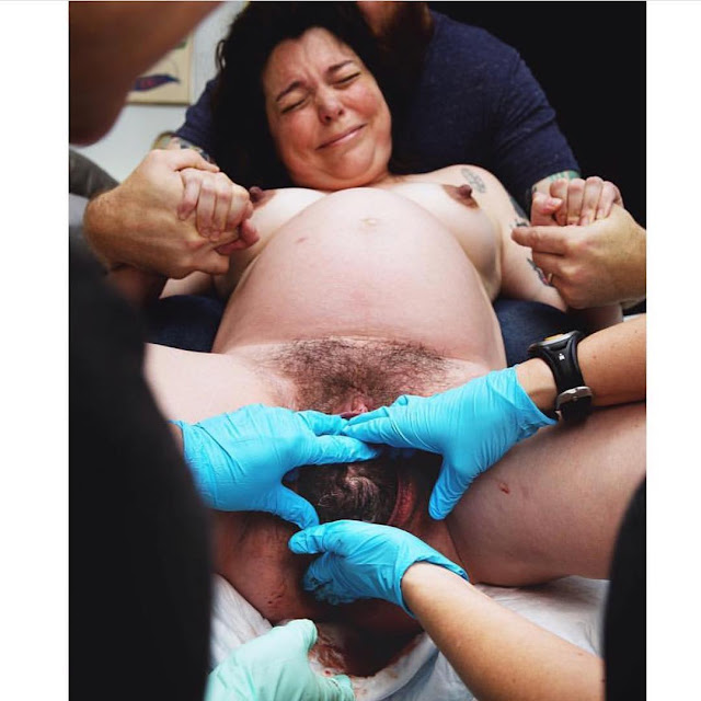 Naked Woman Giving Birth With Help.